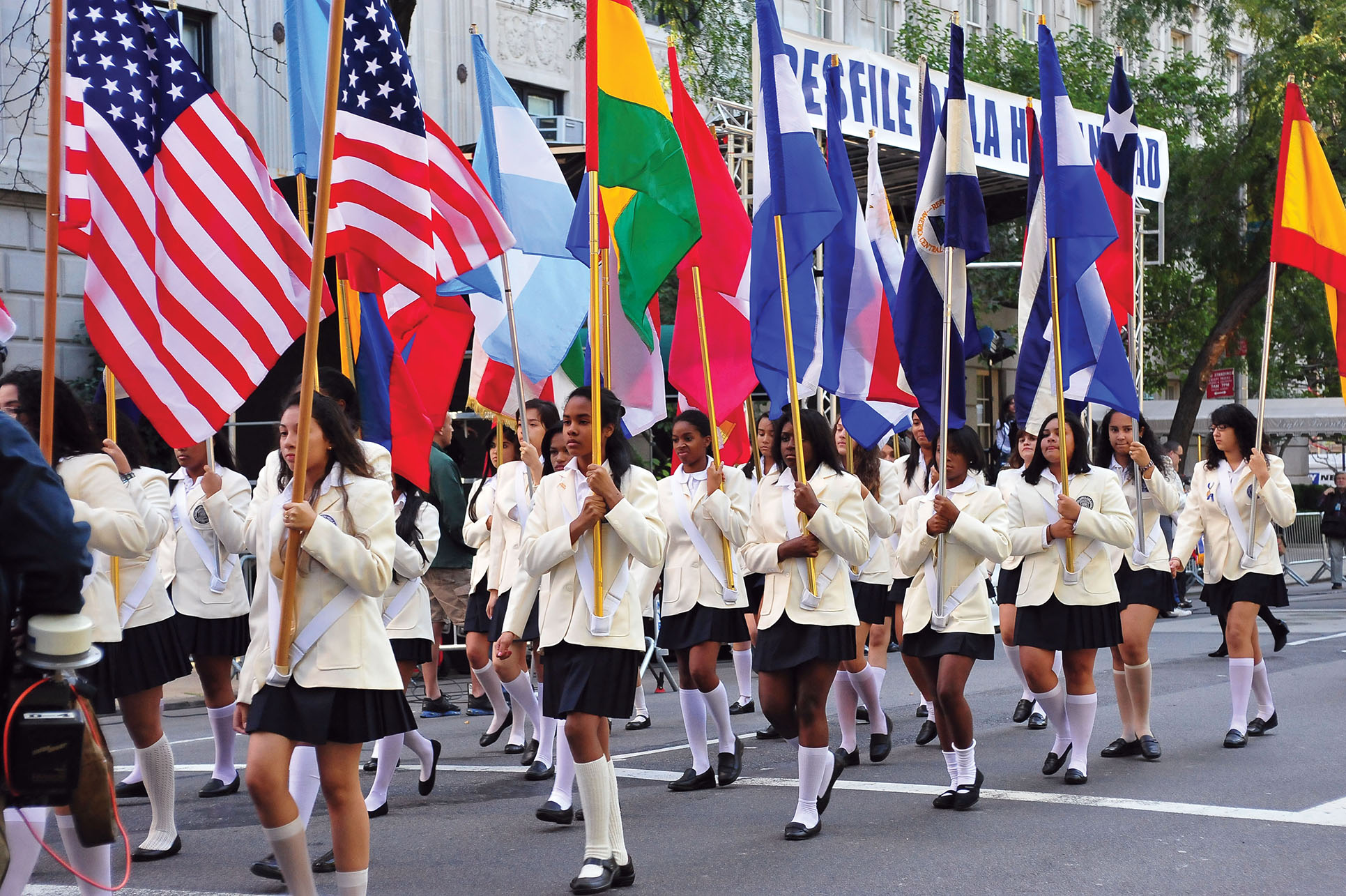 A group of young women carrying Latin American flags march in the Hispanic Day Parade, Fifth Avenue, New York, 2010. (Photo by Asterio Iecson.)