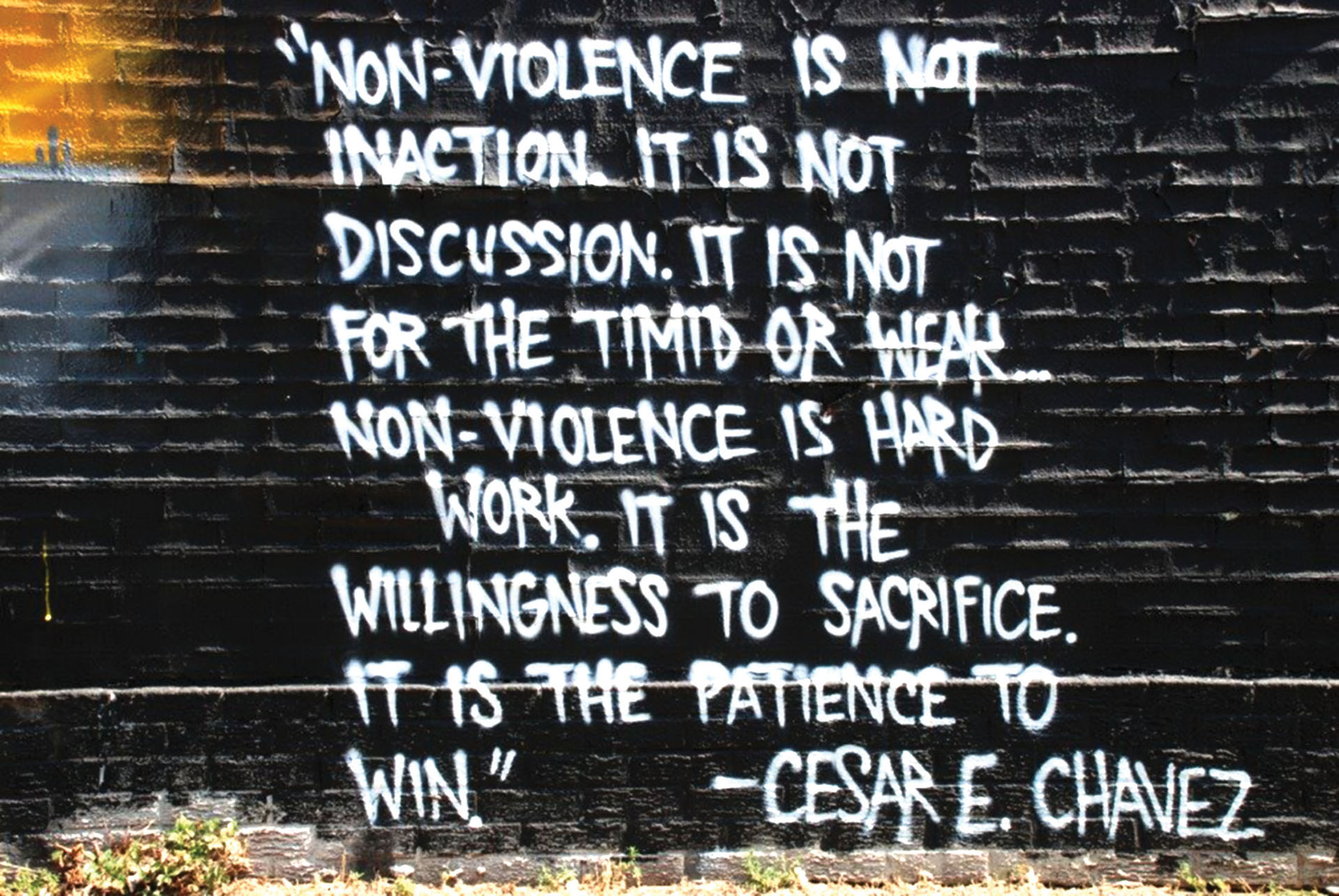 A mural in Denver with a quote from Cesar Chavez about the bravery and patience of non-violence. (Photo by Joe Beine.)