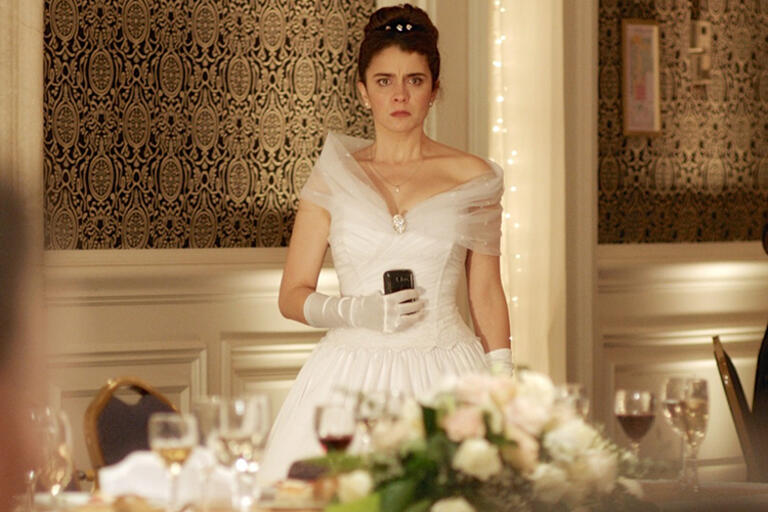 A bride holding a glass 