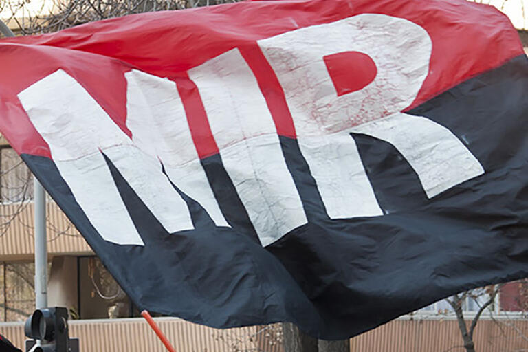 A flag that reads MIR (Movimiento de Izquierda Revolucionaria, or Movement of the Revolutionary Left)
