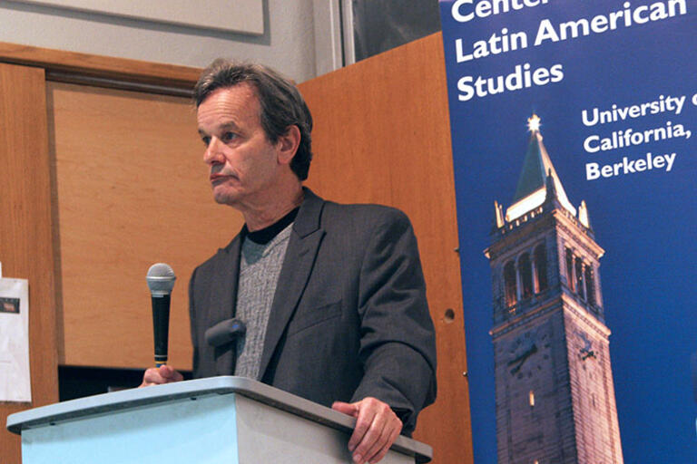 Jeffrey L. Gould speaking with a microphone 