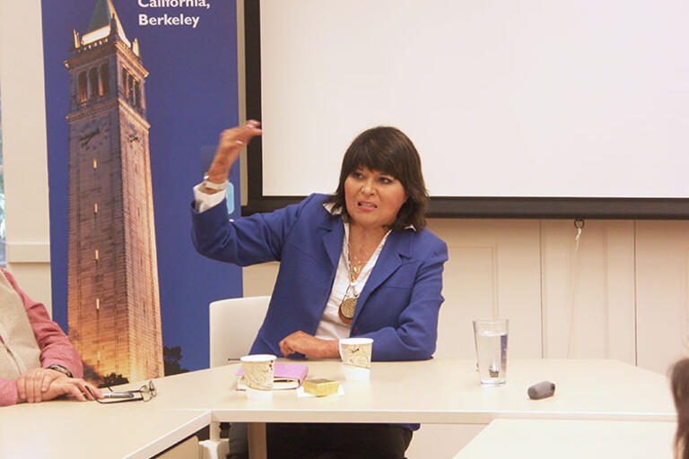 Carmen Gloria Quintana answers questions from the audience, March 2016. (Photo by Marimar Arango-Gomez.) Carmen Gloria Quintana wearing a purple jacket seating down, answering questions from the audience, March 2016