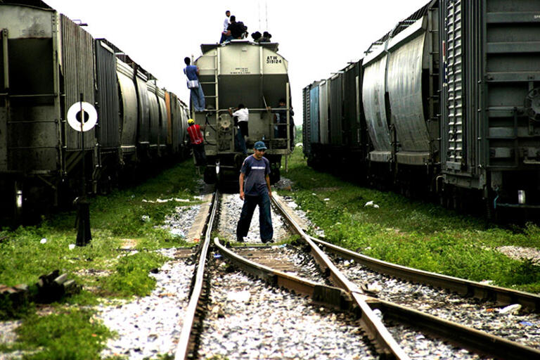 Central American migrants board a train for the long journey north through Mexico. (Photo by Peter Haden.) Picture of a train