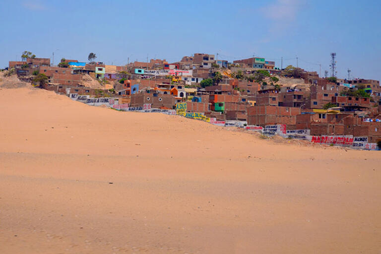 The small town of Lurín, Peru. (Photo by Kristian Golding.) Picture of Lurín, Peru; sand dune and houses