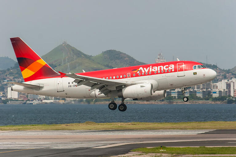 An Avianca jetliner lands at Rio's Santos Dumont Airport. (Photo by Joao Carlos Medau.) A red airplane with the word Avianca painted in white landing at Rio's Santos Dumont Airport