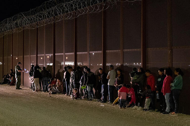 Migrants detained by the U.S. Border Patrol near Yuma, Arizona. (Photo by Jerry Glaser/CBP.) A group of migrants detained by the U.S. Border Patrol near Yuma, Arizona