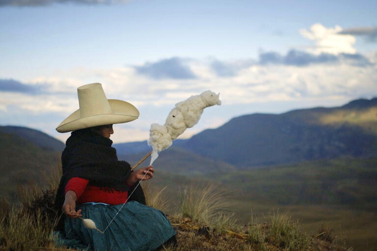 Máxima Acuña spins wool from her sheep. (Image courtesy of TrustFall Films.) Máxima Acuña spins wool from her sheep. (Image courtesy of TrustFall Films.)