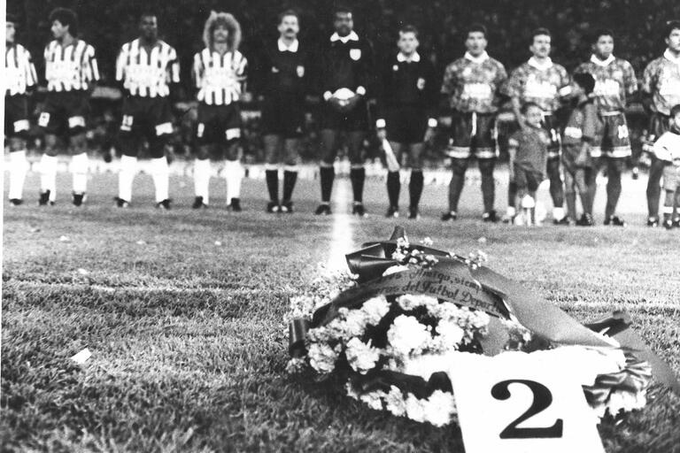A wreath with Andrés Escobar's #2 on it lies on the field as his team lines up for a memorial for a murdered teammate. (Photo courtesy of All Rise Films.)