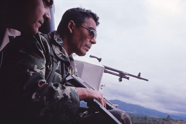 General Benedicto Lucas García, head of the Guatemalan Armed Forces, 1982. (Photo by Susan Meiselas.) General Benedicto Lucas García, head of the Guatemalan Armed Forces, rides in a helicopter holding an assault rifle in 1982. (Photo by Susan Meiselas.)