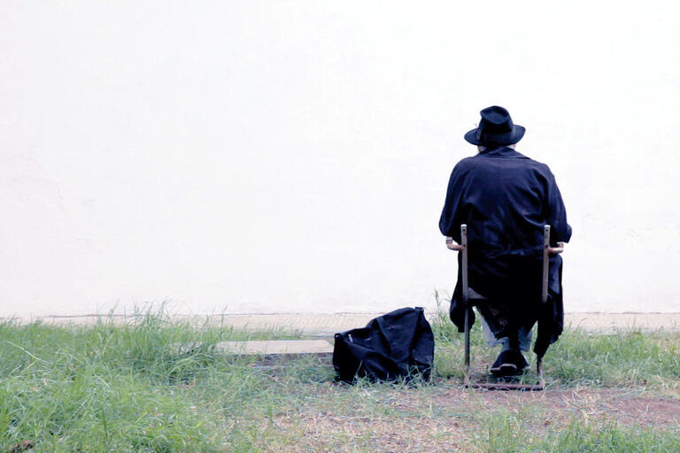 Fernando Birri, starring as Remoro Barroso, sits facing a blank wall in a scene from the movie. (Photo courtesy of Orgon Films.)