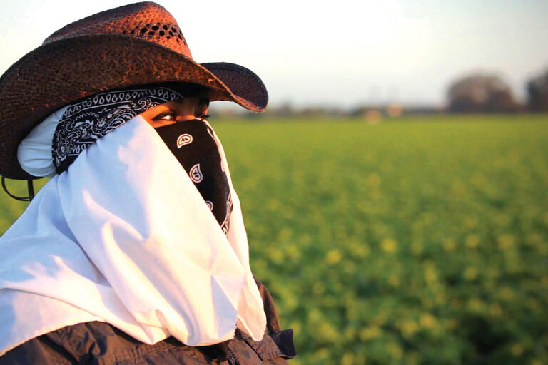 Maricruz Ladino stands in an agricultural field in Salinas. (Photo by Andrés Cediel.)