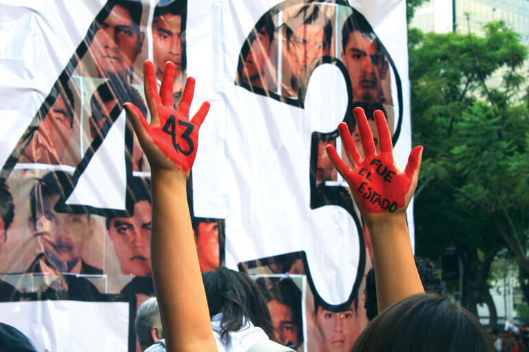 Bloody hands claim “It was the state” on the third anniversary of the disappearance of 43 students in Iguala, Mexico. (Photo by Adrián Martínez.) A photo of hands covered in fake blood in front of a poster reading “It was the state” on the third anniversary of the disappearance of 43 students in Iguala, Mexico. (Photo by Adrián Martínez.)