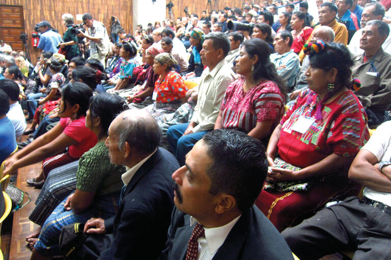 The Guatemalan courtroom audience, in a mixture of Indigenous and formal dress, watches the Ríos Montt trial proceed. (Photo by Anthony Fontes.)