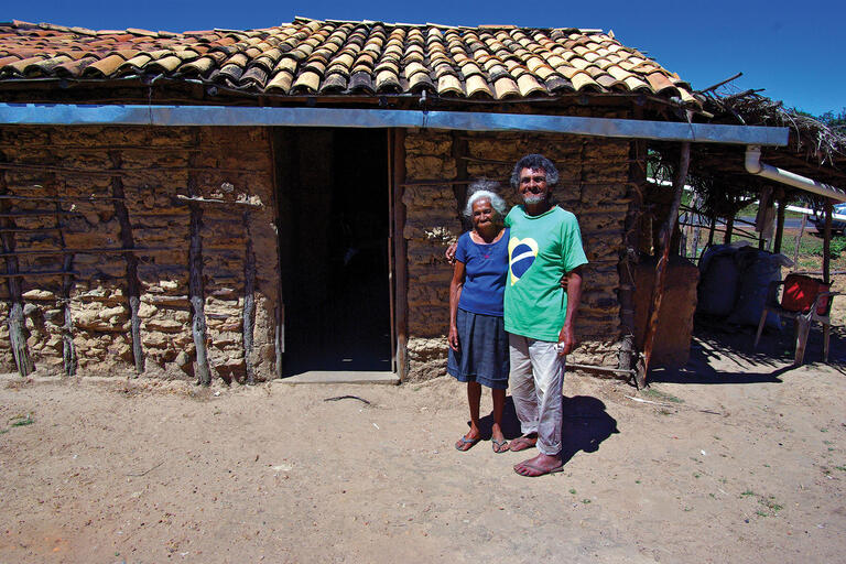 People like this elderly couple are the beneficiaries of some of Brazil’s social programs. (Photo by Otávio Nogueira.) People like this elderly couple standing in front of their home are the beneficiaries of some of Brazil’s social programs. (Photo by Otávio Nogueira.)