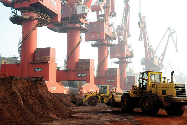 Giant wheel loaders transport rare earths amidst the cranes at the Port of Lianyungang, China. (Photo by Wang Chun Lyg/Associated Press.)