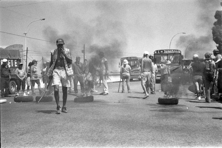 Piqueteros burn tires to block a road during a 2001 protest in Buenos Aires, Argentina. (Photo by Andre Deak.)