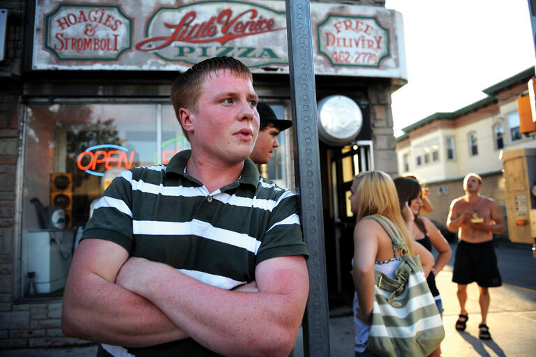Main Street, Shenandoah, Pennsylvania. (Photo by and © David Turnley.) A young white man stands with his arms crossed on Main Street, Shenandoah, Pennsylvania. (Photo by and © David Turnley.)