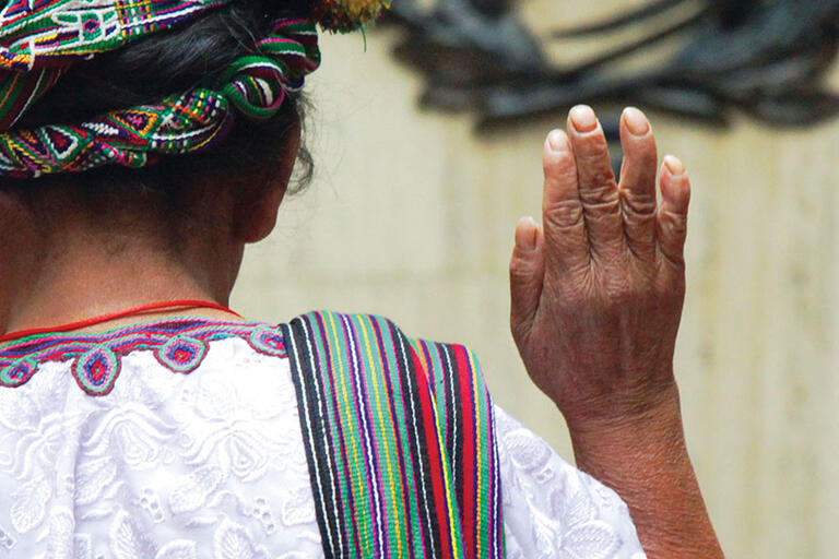 A Mayan woman in traditional dress stands to be sworn in as she testifies at the trial of Efraín Ríos Montt in Guatemala. (Photo by trocalre.)