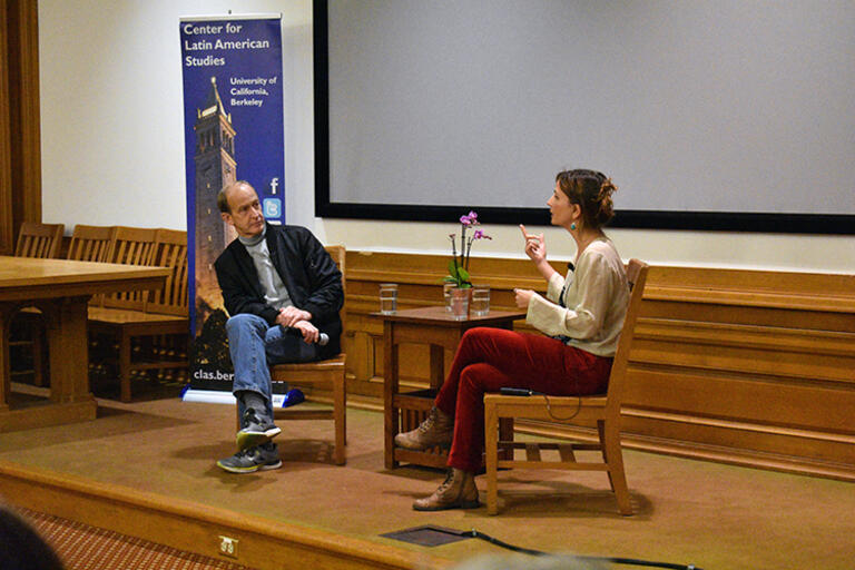 Costa explains her concerns with the state of Brazilian democracy to Ferguson. (Photo by Ana De Carolis.) Petra Costa and Charles Ferguson seating in conversation with each other