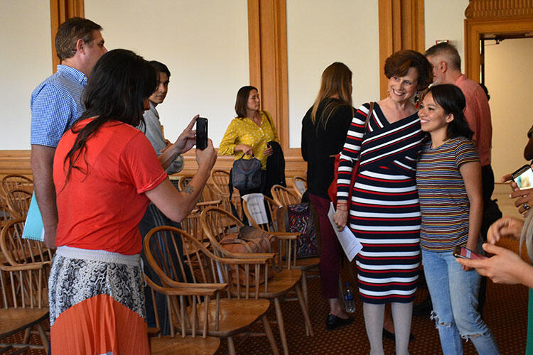 Denise Dresser takes a photo with a young woman