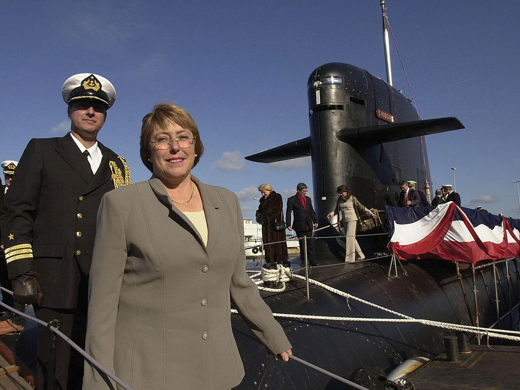 Michelle Bachelet walks down a gangplank after inspecting a submarine as Chile’s Defense Minister, 2003. (Photo by Mychele Daniau/Getty Images.)