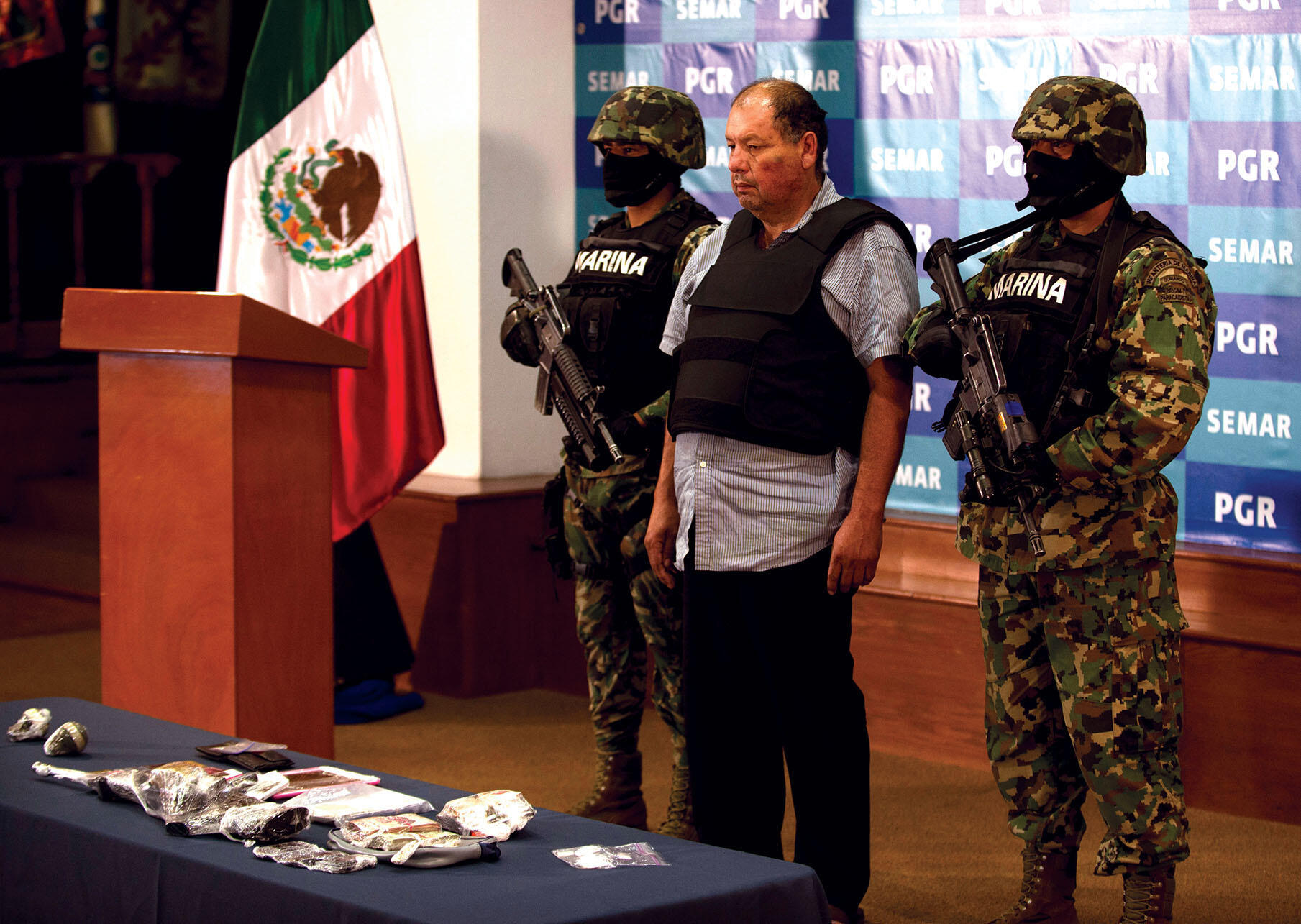 Mexican naval forces show off the captured Mario Cárdenas Guillén, alleged leader of the Gulf cartel, at a press conference in 2012. (Photo by Yuri Cortez/AFP/Getty Images.)