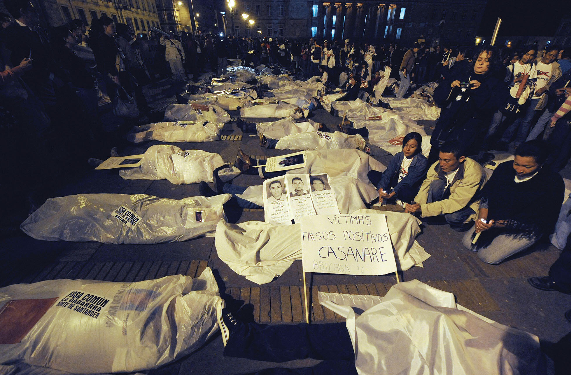 Protestors lie on the ground to pose as the victims in the “falsos positivos” scandal, 2009. (Photo by Mauricio Dueñas/AFP/Getty Images.)
