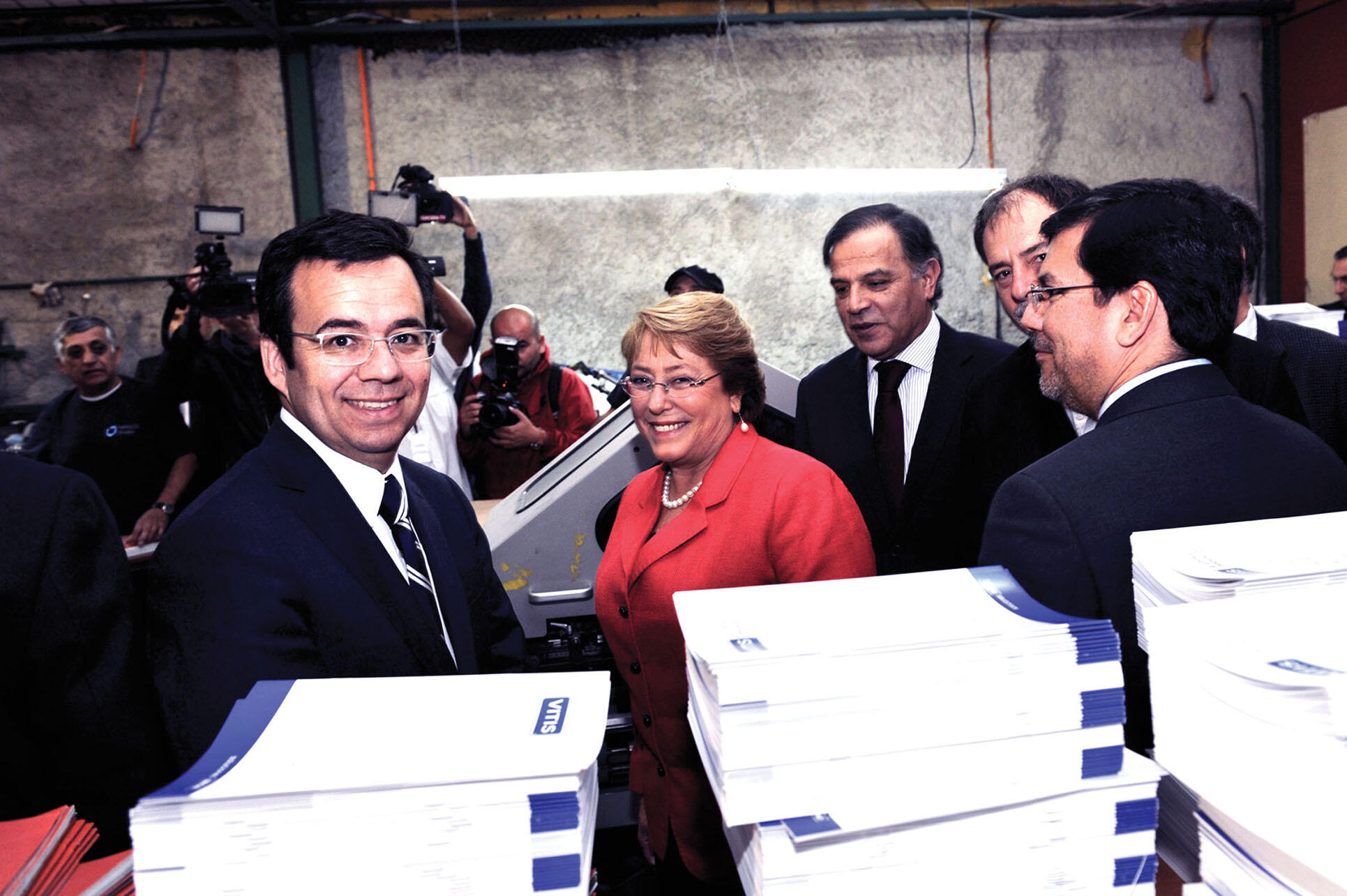 Luis Felipe Céspedes, minister of economy (far left), President Michelle Bachelet (center),  and Alberto Arenas de Mesa, minister of finance (far right) promote the benefits of the Chilean tax reform. (Photo from the Chilean Ministry of the Economy.)