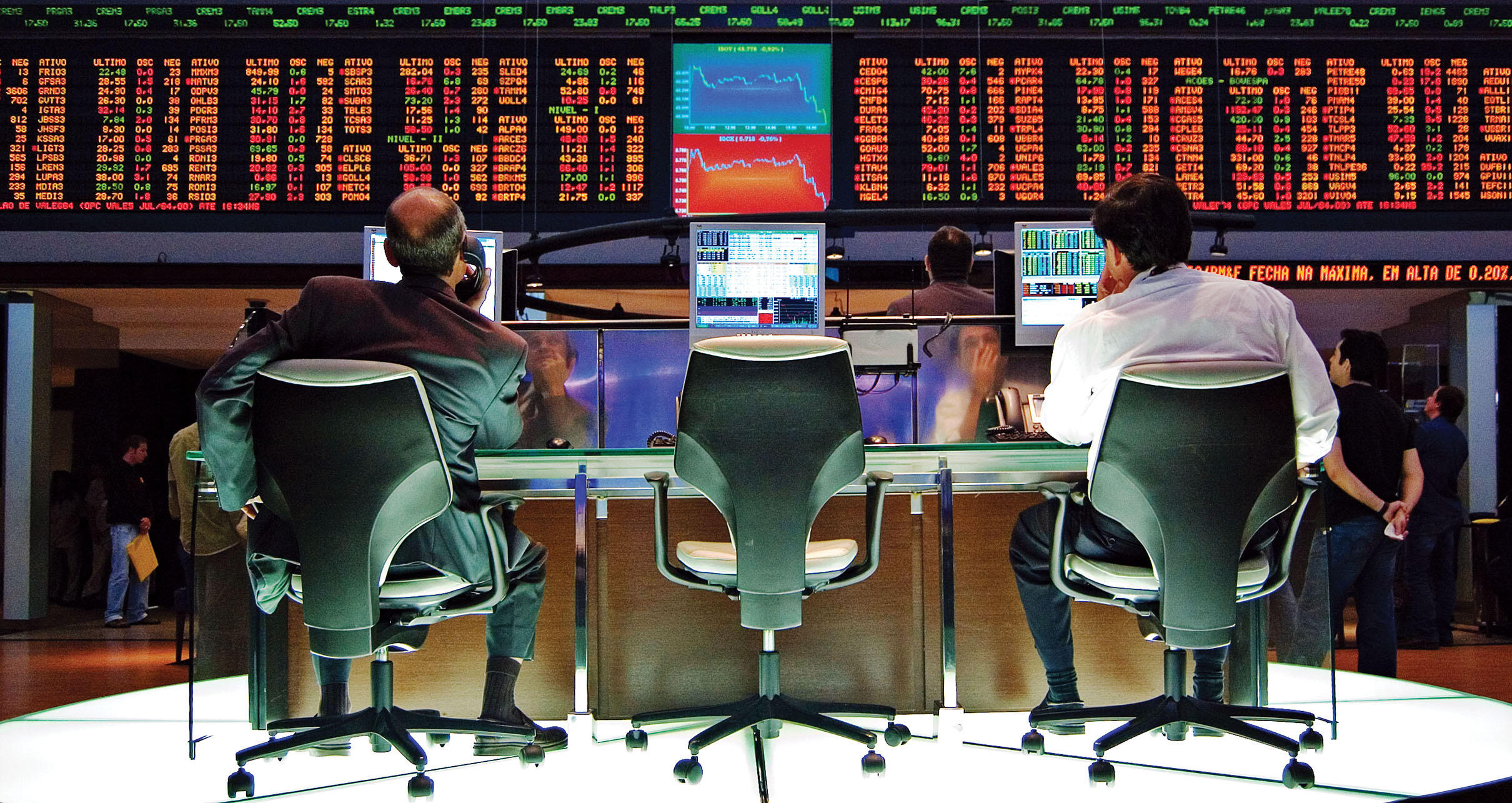 Stock traders watch prices fluctuate at a stock exchange in São Paulo. (Photo by Rafael Matsunaga.)
