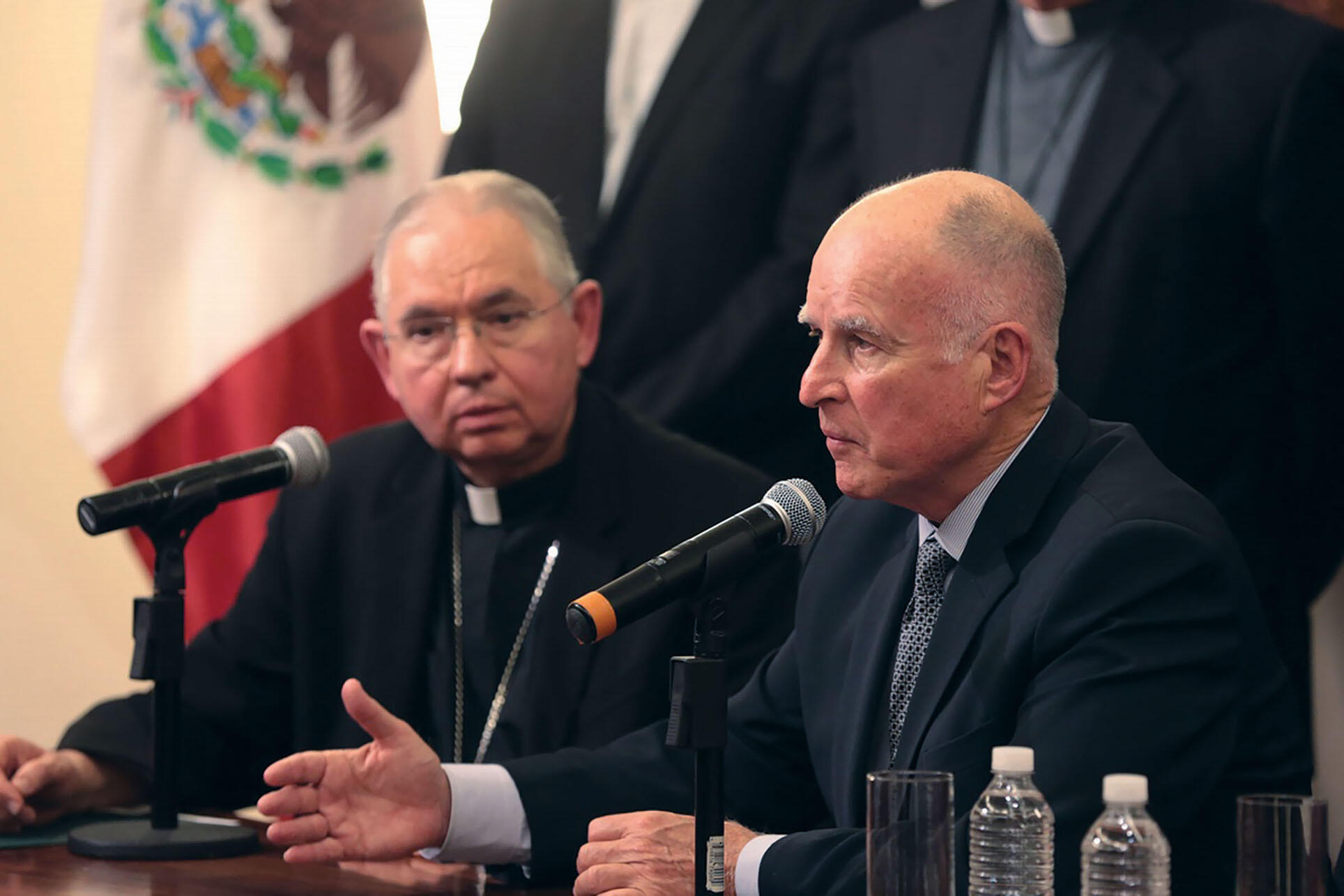 Governor Jerry Brown and Archbishop José Gómez at a Mexico press conference on unaccompanied minors at the U.S. border, July 2014. (Photo by Justin Short, Office of the Governor of California.) Governor Jerry Brown and Archbishop José Gómez at a Mexico pr Governor Jerry Brown and Archbishop José Gómez at a Mexico press conference on unaccompanied minors at the U.S. border, July 2014. (Photo by Justin Short, Office of the Governor of California.) Governor Jerry Brown and Archbishop José Gómez at a Mexico pr