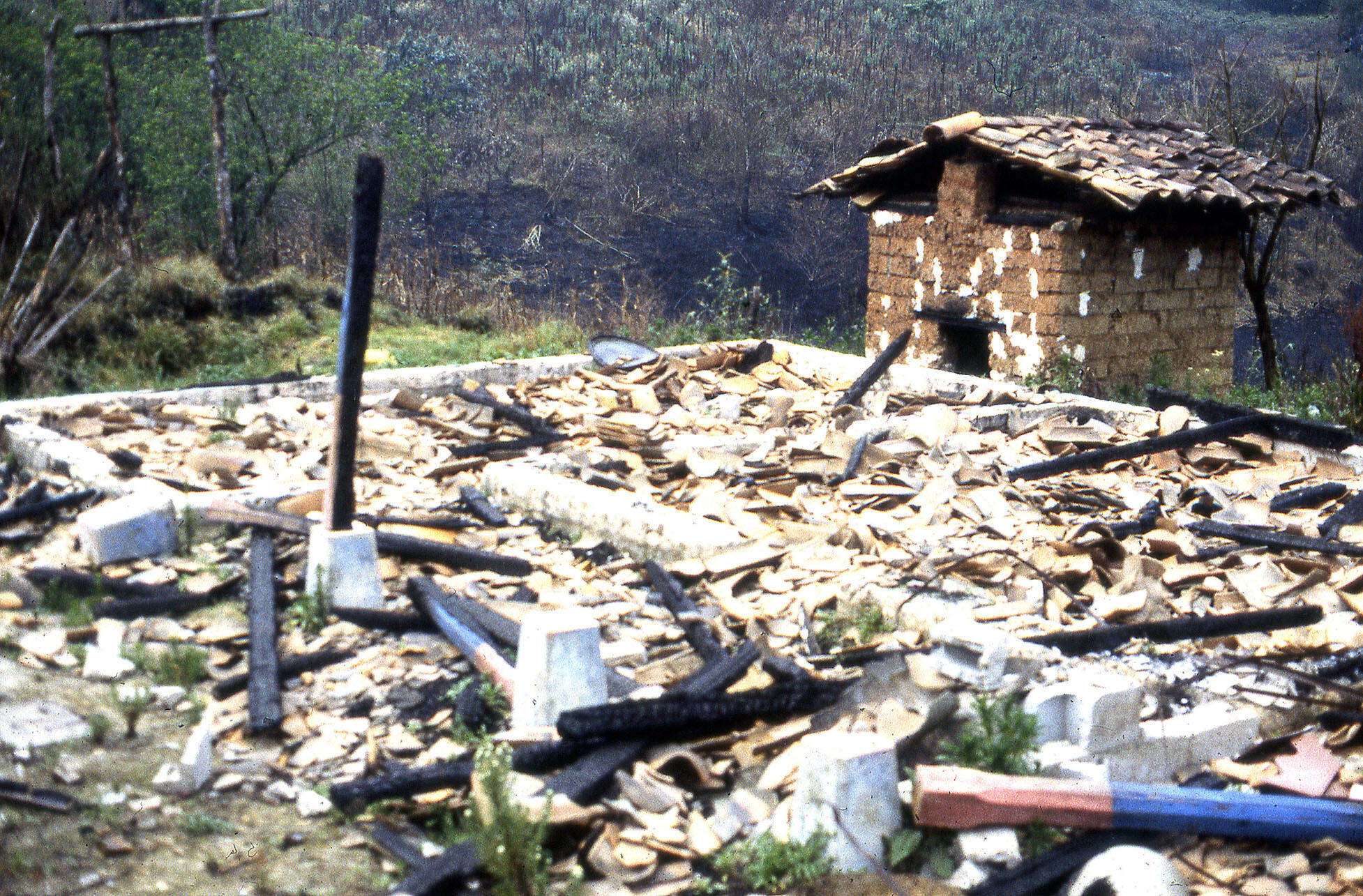 The ruins of a house that has been demolished and burnt along the road to the Ixil region, Guatemala, March 1983. (Photo courtesy of Beatriz Manz.)