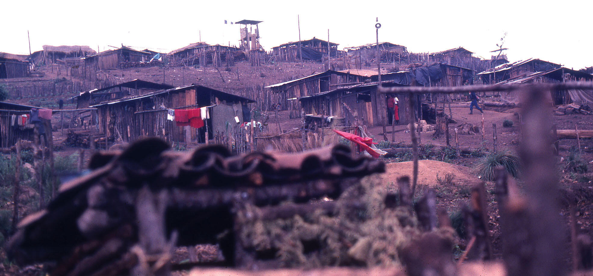 The huts and muddy streets of the “model village” of La Pista, Ixil region, Guatemala, March 1983. (Photo courtesy of Beatriz Manz.)