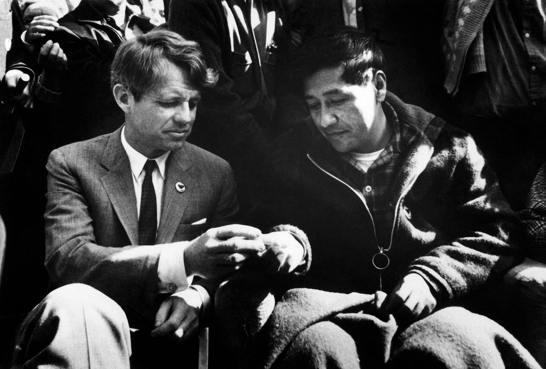 Cesar Chavez breaks his 1968 fast by sharing bread with Robert Kennedy. (Copyright Bettmann/Corbis/AP Images.)