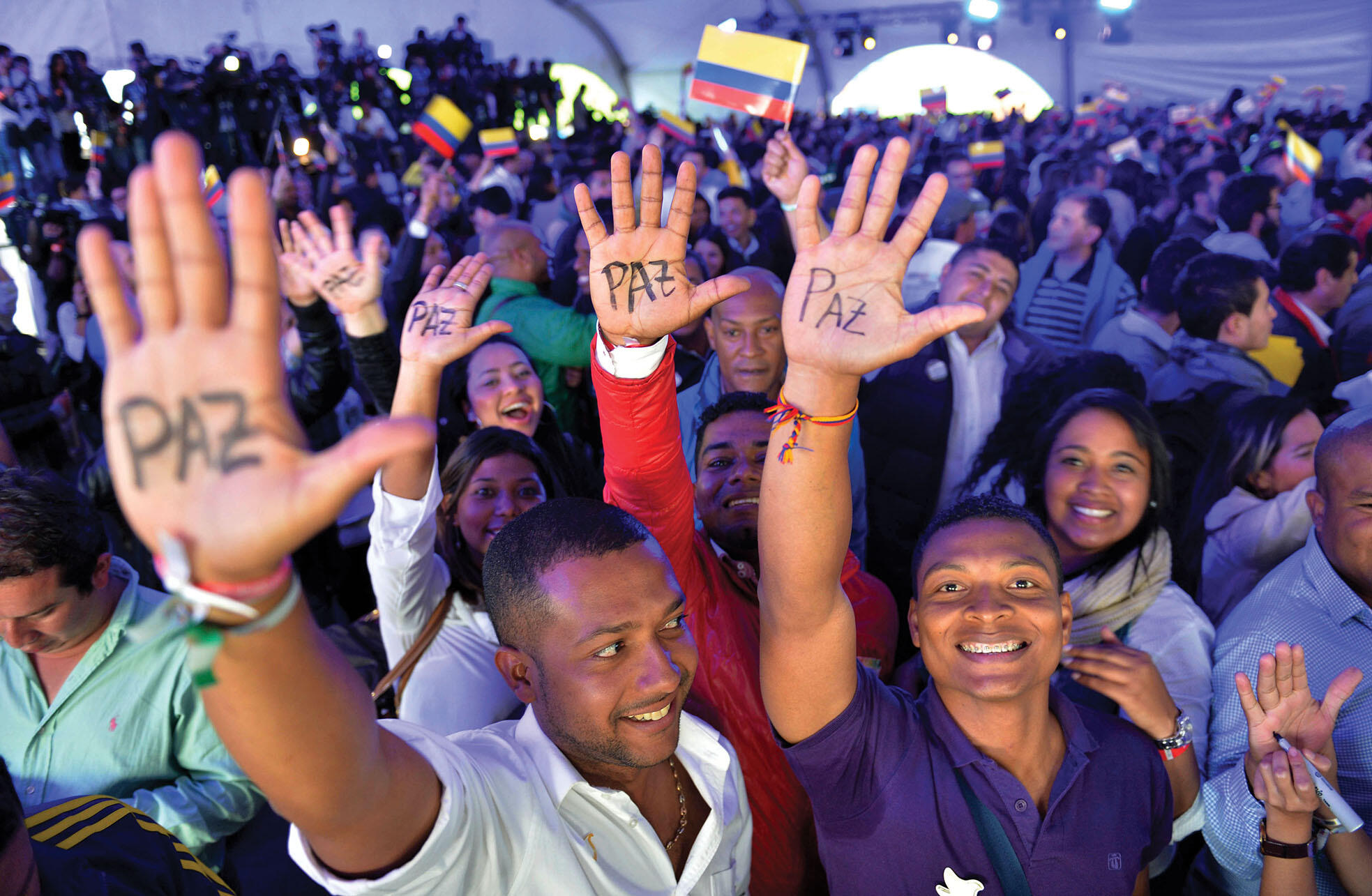 Supporters of President Santos with “peace” written on their hands celebrate his victory in the runoff election. (Photo by Santiago Cortez/Associated Press.)
