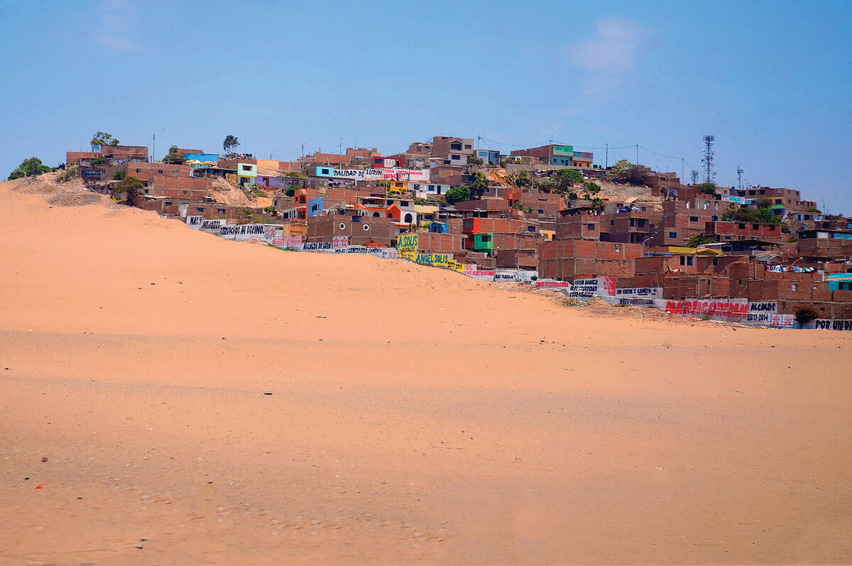A spreading desert in the foreground for the isolated town of Lurín, Peru. (Photo by Kristian Golding.)