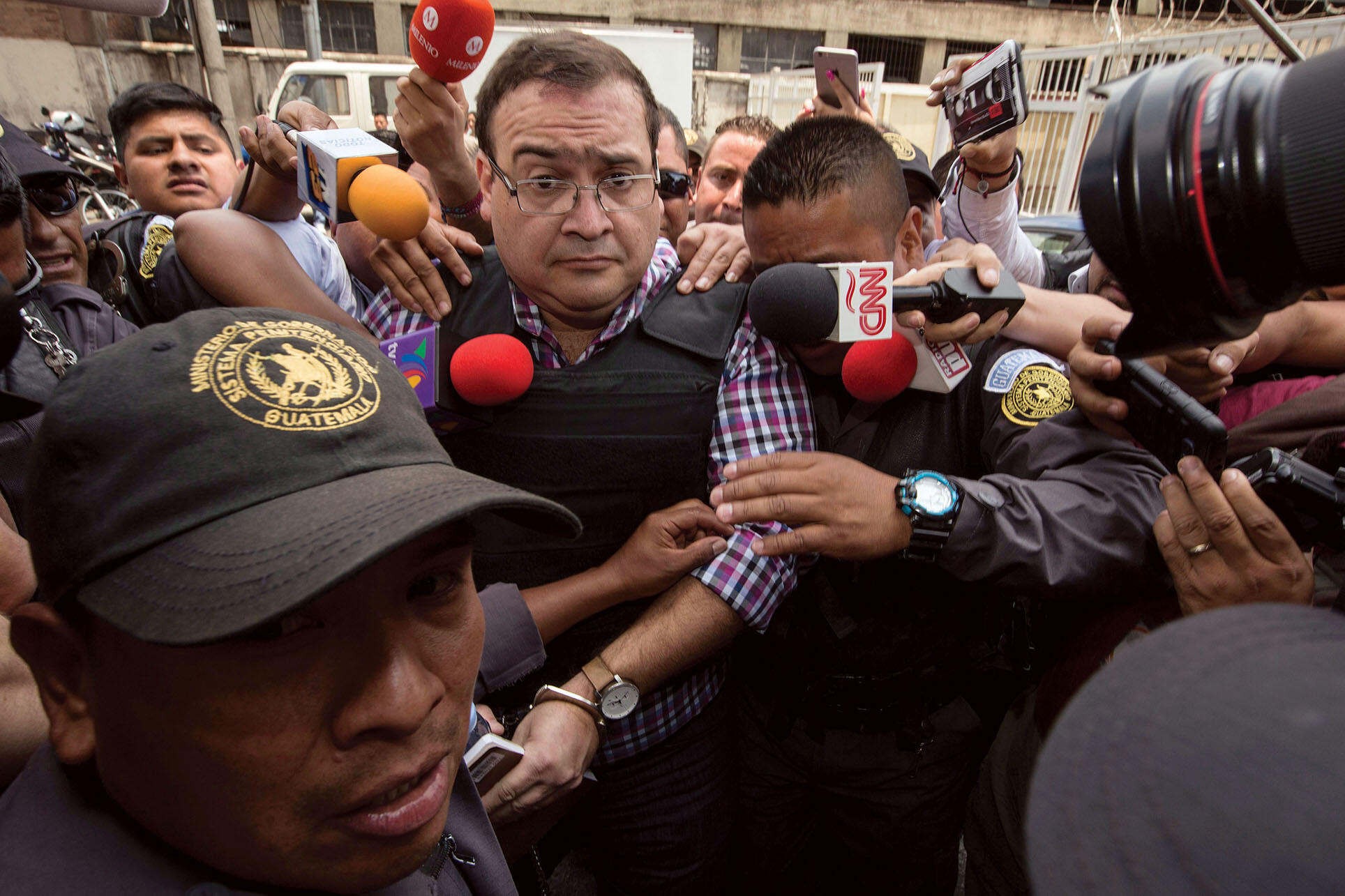 Mexico’s former governor of  Veracruz, Javier Duarte, is led through a crowd of reporters to an extradition hearing in Guatemala. (Photo by Moises Castillo/Associated Press.)