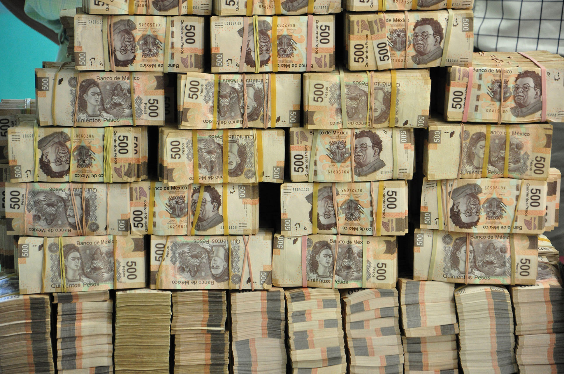 A huge stack of cash found in the office of an assistant to the governor of Tabasco in 2013. (Photo by America Rocio/Associated Press.)