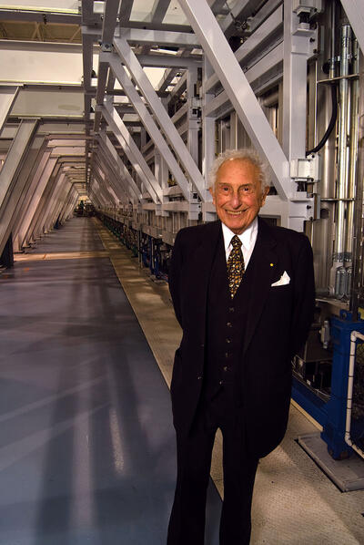 Stan Ovshinsky with his “printing press,” which produced flexible solar materials by the mile. (Photo by Brendan Ross.)